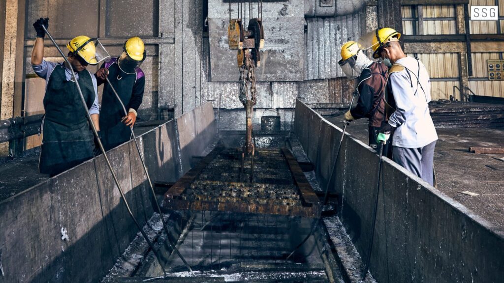 Workers in industrial environment with machinery