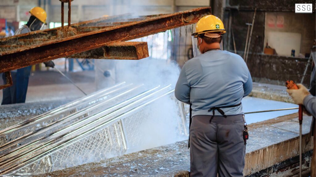 Workers in industrial metal processing facility